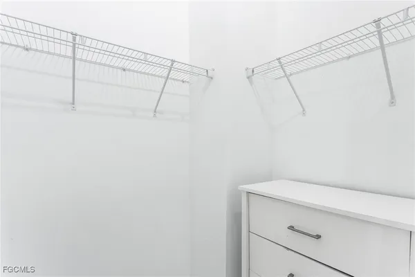 a bedroom with a bed and a potted plant