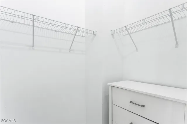 a bedroom with a bed and a potted plant