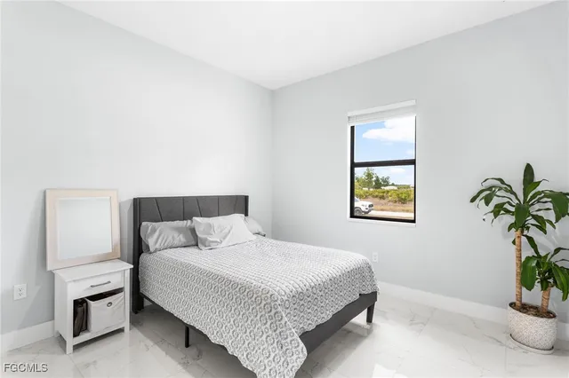 a bedroom with a bed and a potted plant