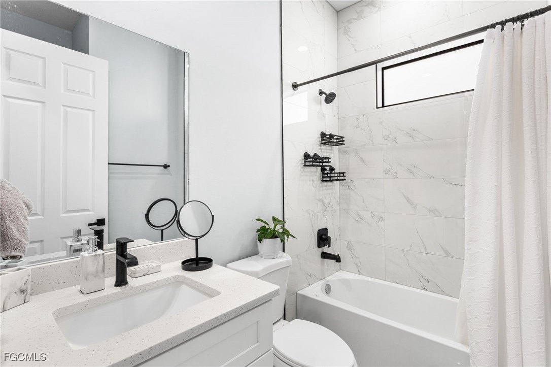 7583 15th Place LaBelle, FL 33935 - Photo 29 of 34 a bathroom with a sink and a mirror