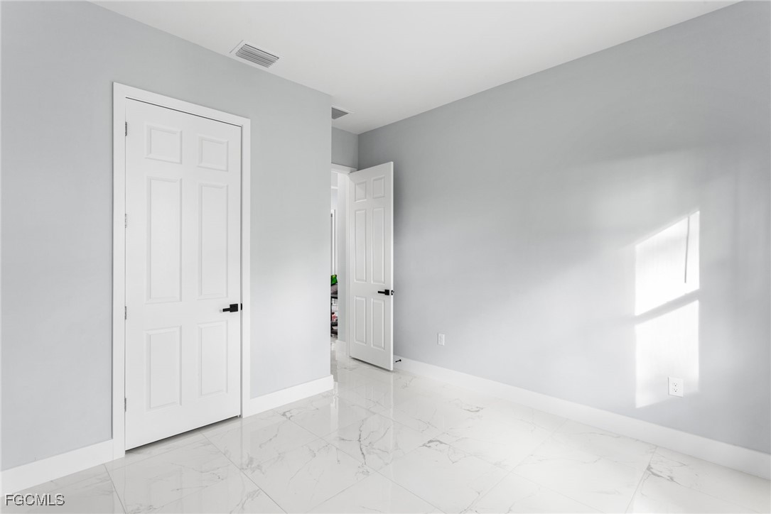 7583 15th Place LaBelle, FL 33935 - Photo 30 of 34 an empty room with windows and closet