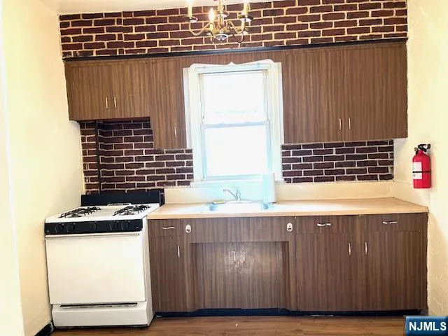 a kitchen with a sink a stove and a microwave