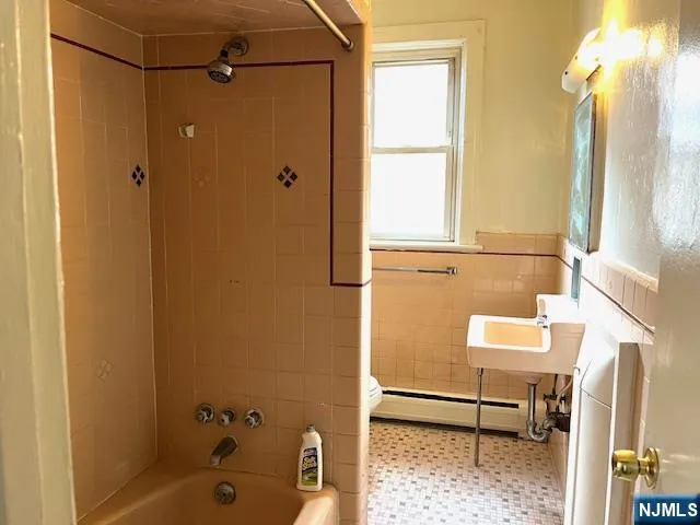 a bathroom with a tub and a shower