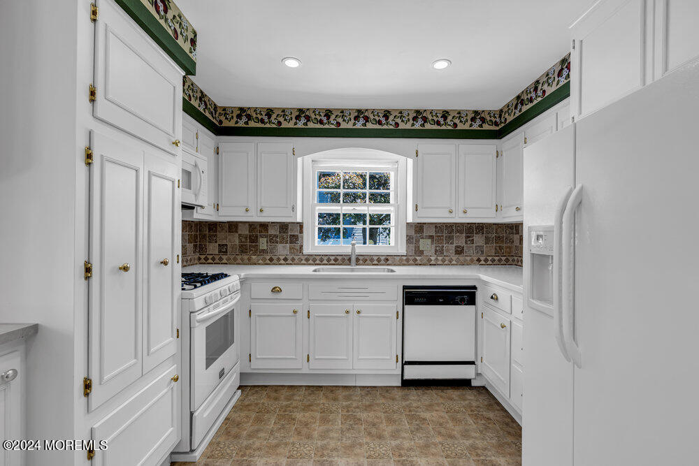 4 Cherry Place Manasquan, NJ 08736 - Photo 18 of 46 a kitchen with white cabinets and white appliances