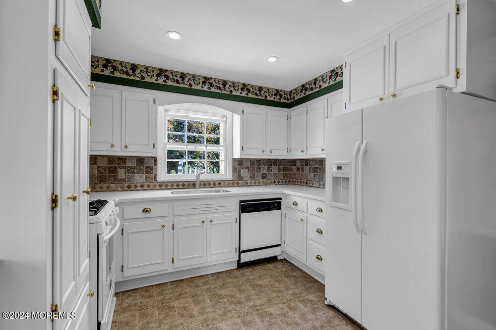4 Cherry Place Manasquan, NJ 08736 - Photo 19 of 46 a kitchen with white cabinets and white appliances