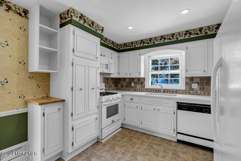 4 Cherry Place Manasquan, NJ 08736 - Photo 20 of 46 a kitchen with white cabinets and white appliances