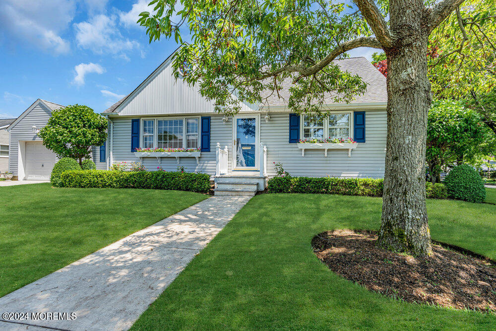 4 Cherry Place Manasquan, NJ 08736 - Photo 2 of 46 a front view of a house with a yard and garden