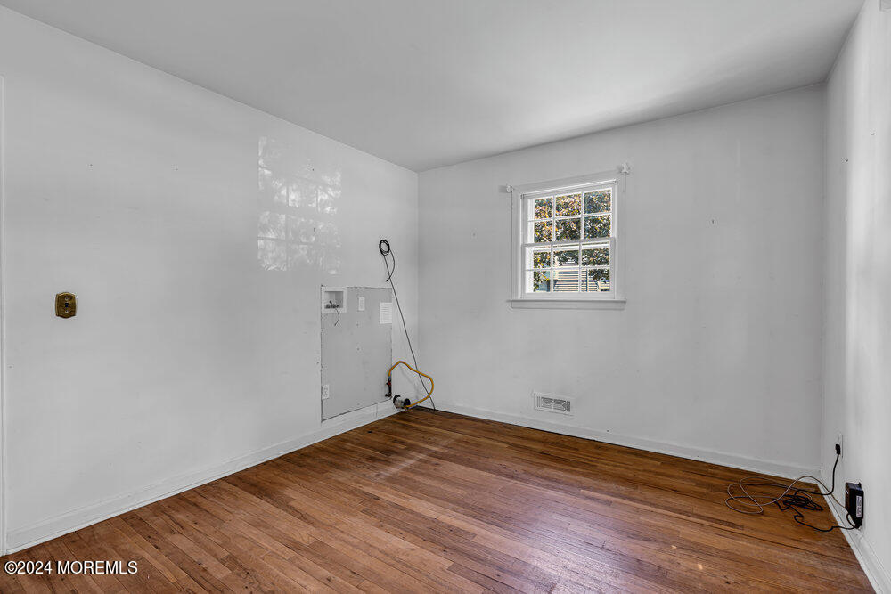 4 Cherry Place Manasquan, NJ 08736 - Photo 25 of 46 an empty room with wooden floor and windows