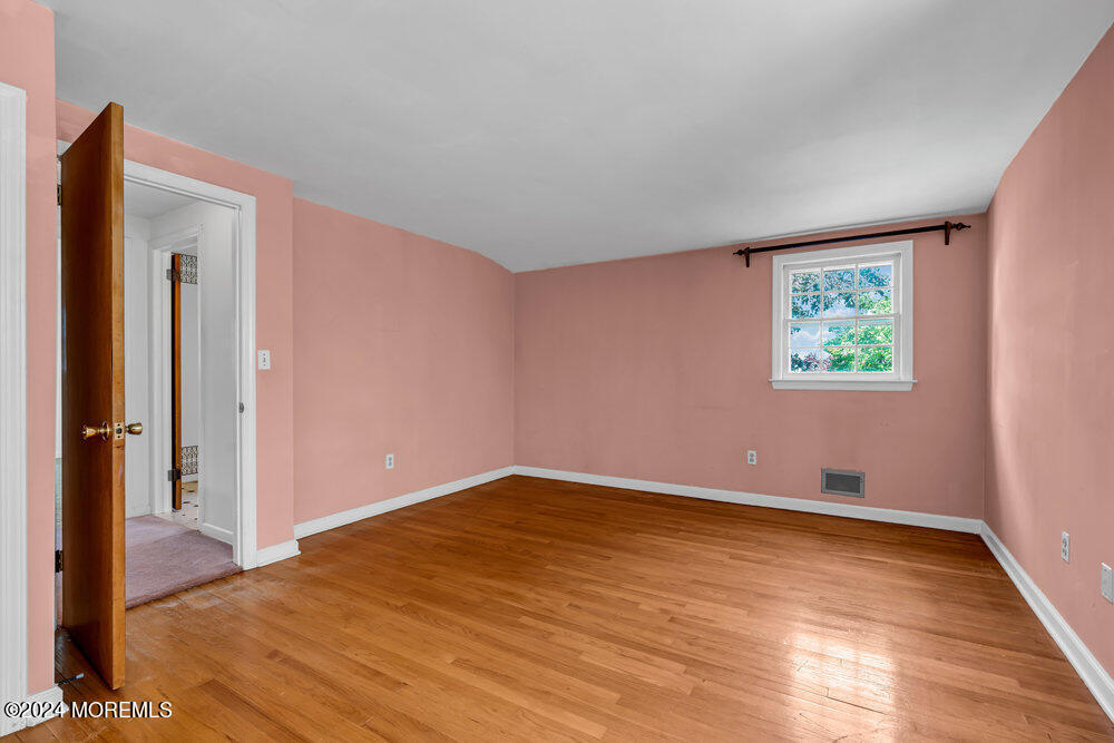 4 Cherry Place Manasquan, NJ 08736 - Photo 33 of 46 an empty room with wooden floor and window