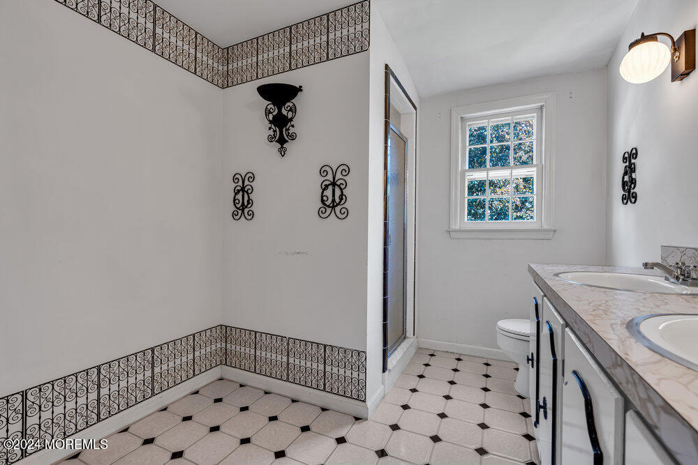 4 Cherry Place Manasquan, NJ 08736 - Photo 36 of 46 a bathroom with a shower and a sink