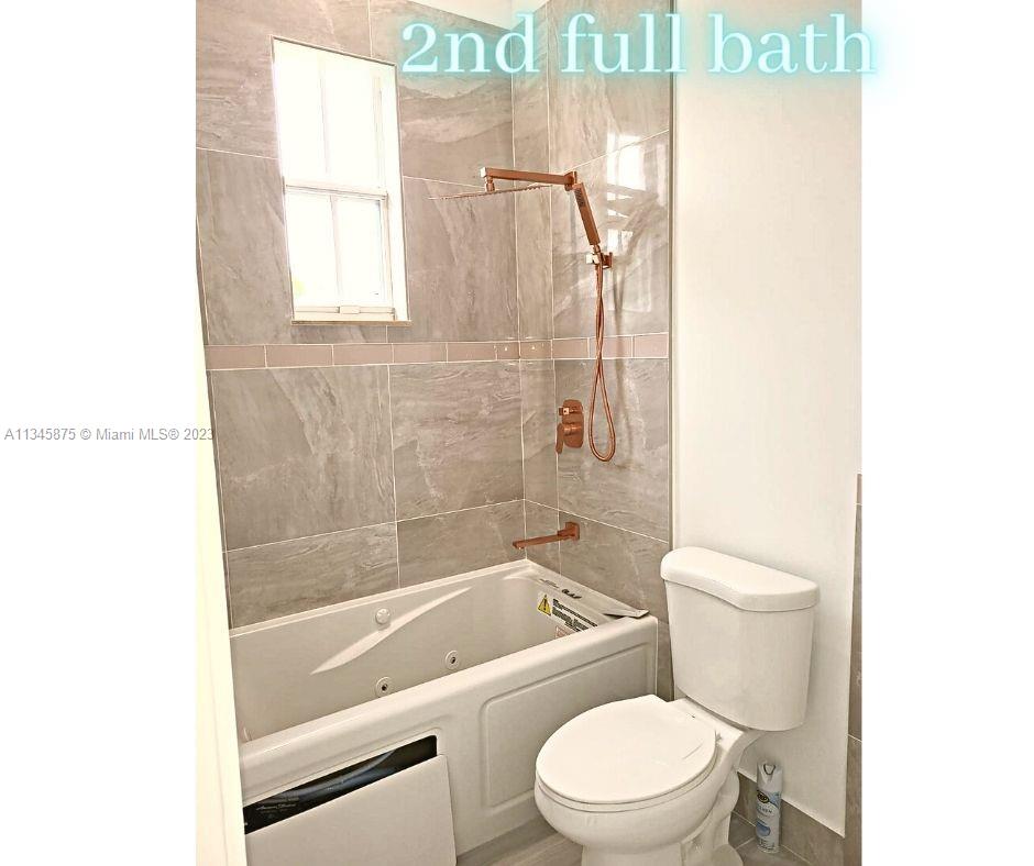 Cobblestone Pembroke Pines, FL 33027 - Photo 8 of 17 a white toilet sitting next to a bath tub