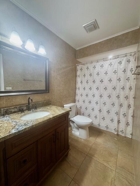 5939 Forest Hill Boulevard, Unit 205 West Palm Beach, FL 33415 - Photo 13 of 19 a bathroom with a sink toilet and mirror