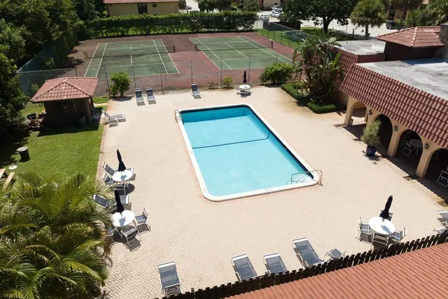 swimming pool view with a seating space