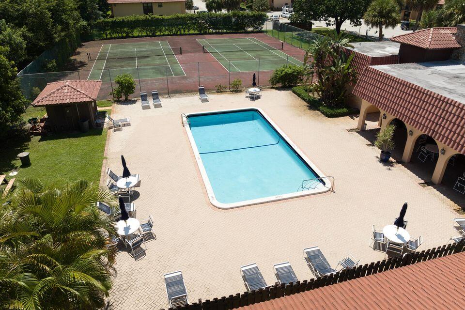 5939 Forest Hill Boulevard, Unit 205 West Palm Beach, FL 33415 - Photo 16 of 19 swimming pool view with a seating space