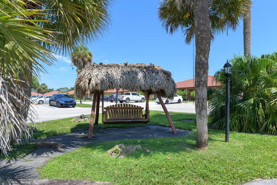 5939 Forest Hill Boulevard, Unit 205 West Palm Beach, FL 33415 - Photo 18 of 19 a view of a yard with a palm trees