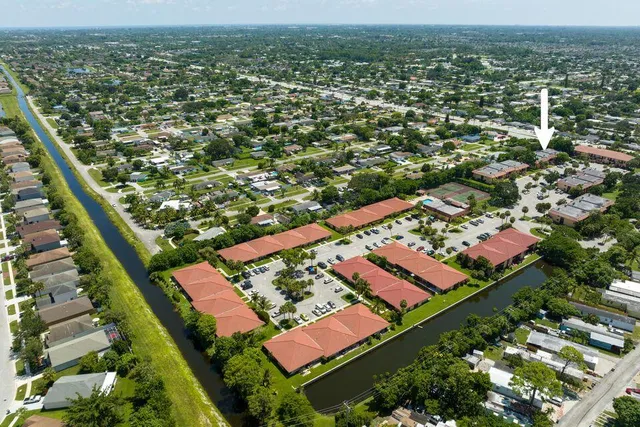 an aerial view of residential houses with outdoor space and swimming pool