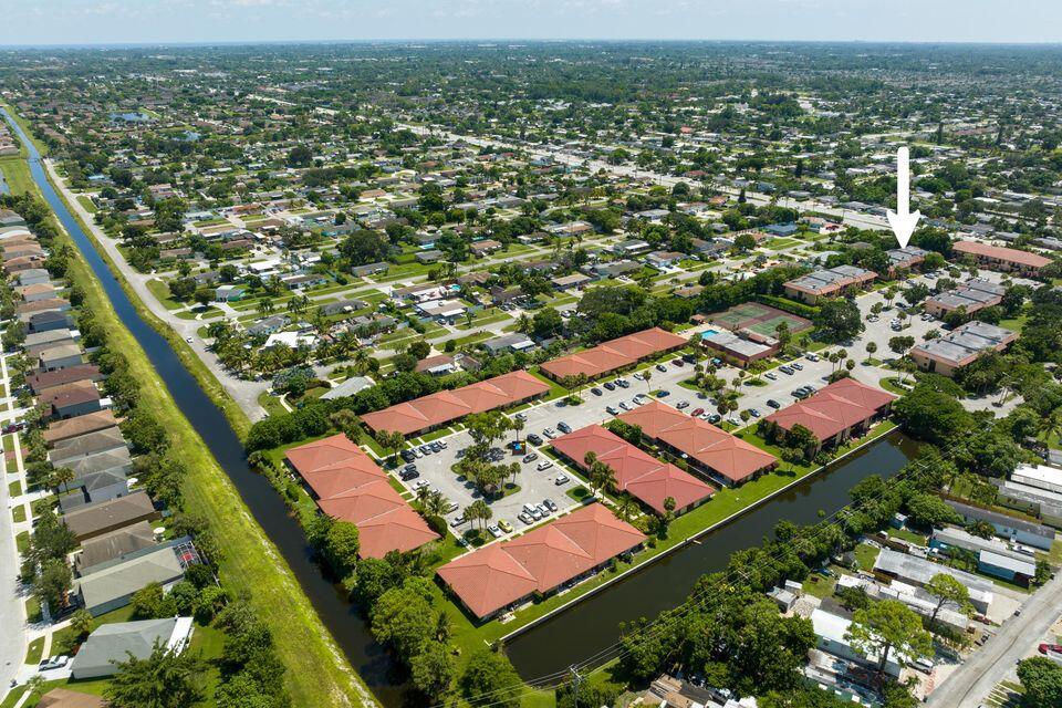 5939 Forest Hill Boulevard, Unit 205 West Palm Beach, FL 33415 - Photo 19 of 19 an aerial view of residential houses with outdoor space and swimming pool