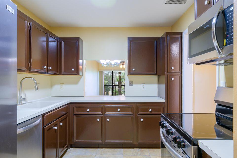 5939 Forest Hill Boulevard, Unit 205 West Palm Beach, FL 33415 - Photo 4 of 19 a kitchen with a sink and cabinets