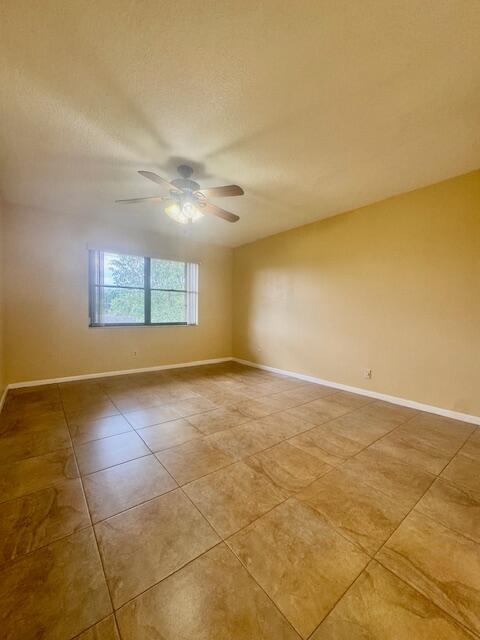 5939 Forest Hill Boulevard, Unit 205 West Palm Beach, FL 33415 - Photo 6 of 19 a view of an empty room with a window
