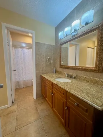 a bathroom with a granite countertop sink a mirror and a