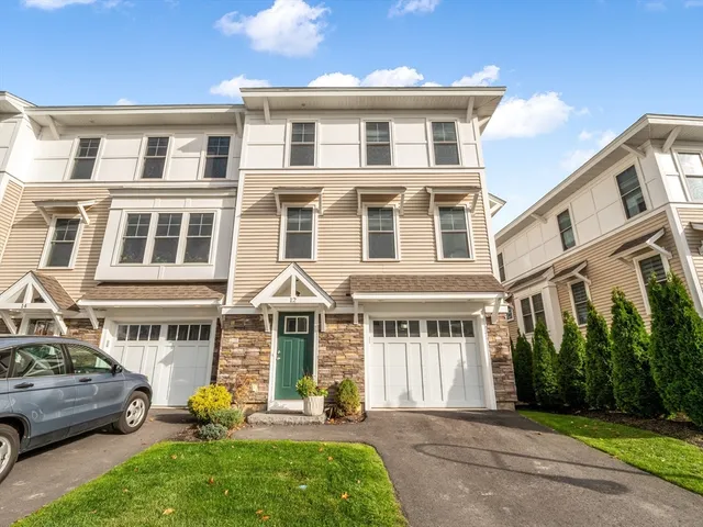 a front view of a residential apartment building with a yard