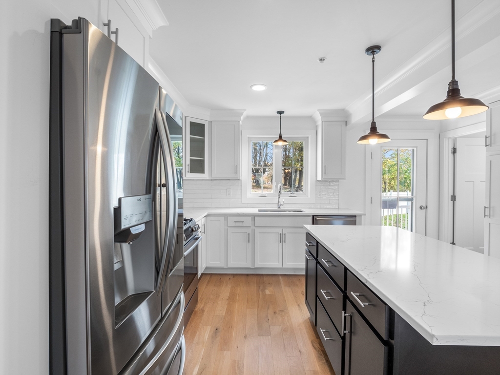 12 Hines, Unit 12 Newburyport, MA 01950 - Photo 11 of 32 a kitchen with stainless steel appliances granite countertop a refrigerator a sink and a stove