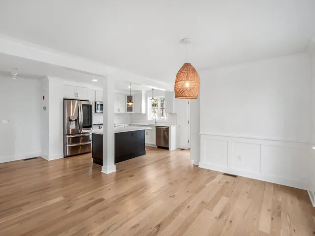 a view of kitchen with sink and wooden floor