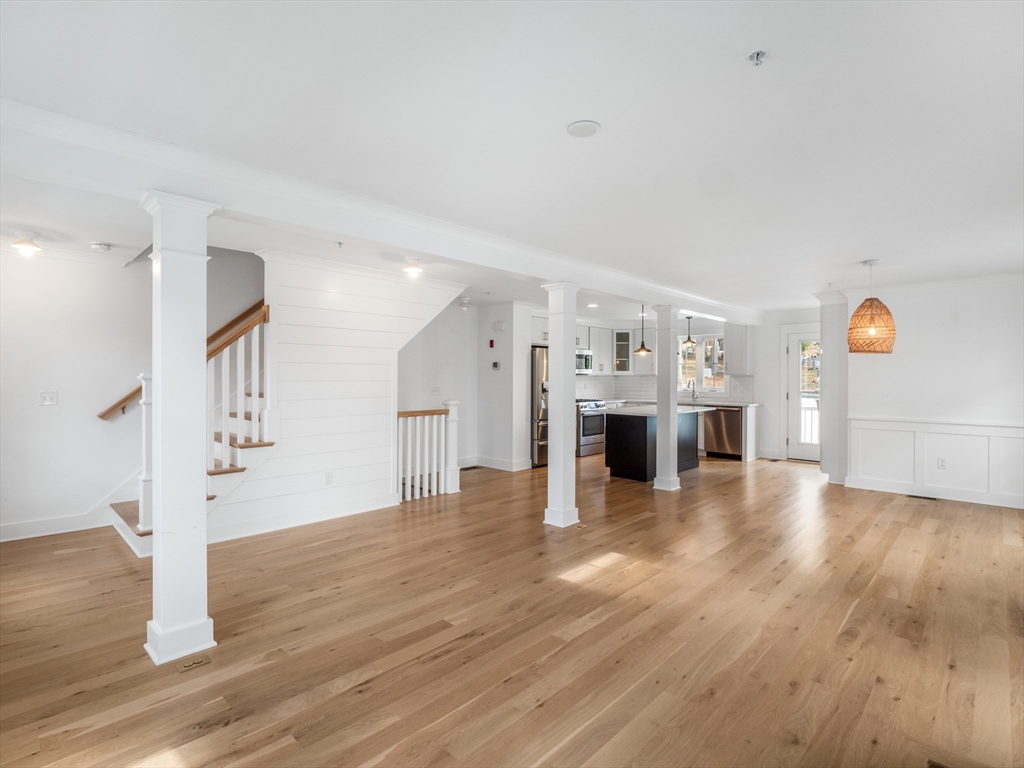 12 Hines, Unit 12 Newburyport, MA 01950 - Photo 23 of 32 a view of a livingroom with a fireplace and stairs