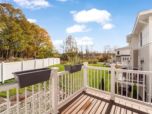 a view of balcony with wooden floor and fence