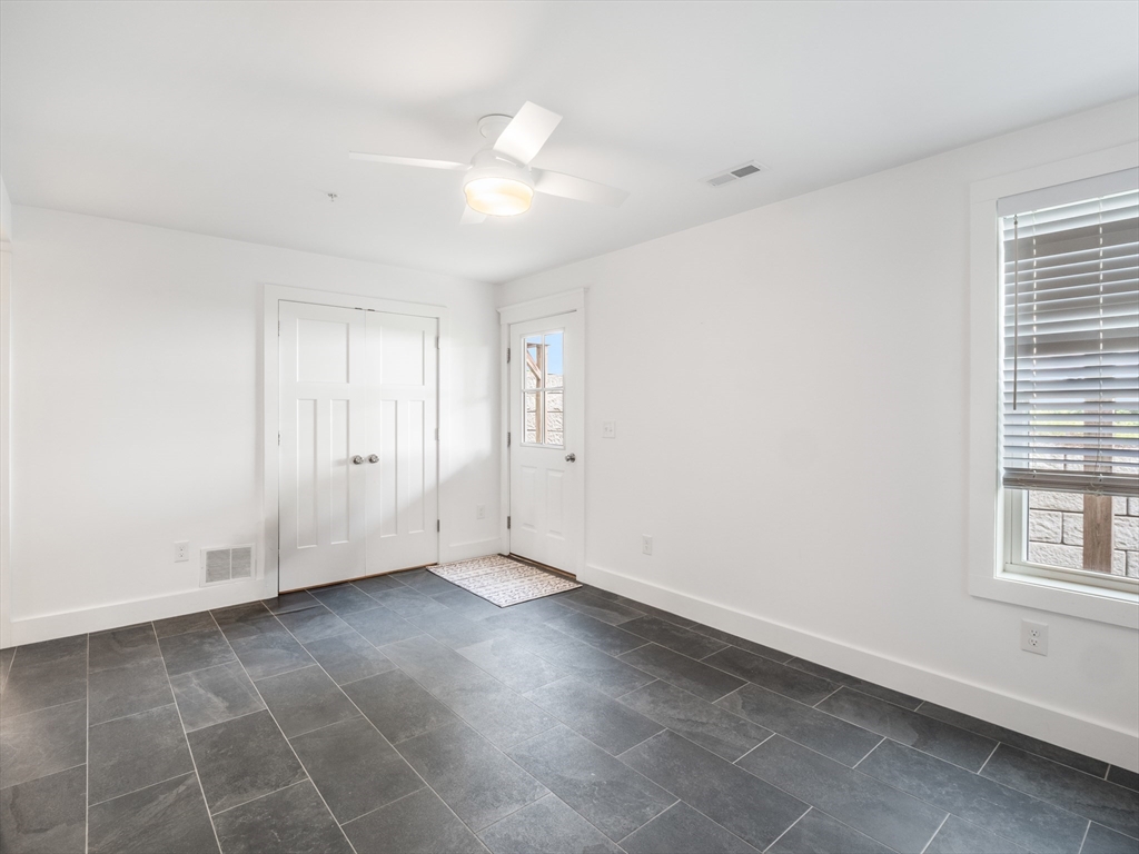 12 Hines, Unit 12 Newburyport, MA 01950 - Photo 8 of 32 an empty room with windows and fan