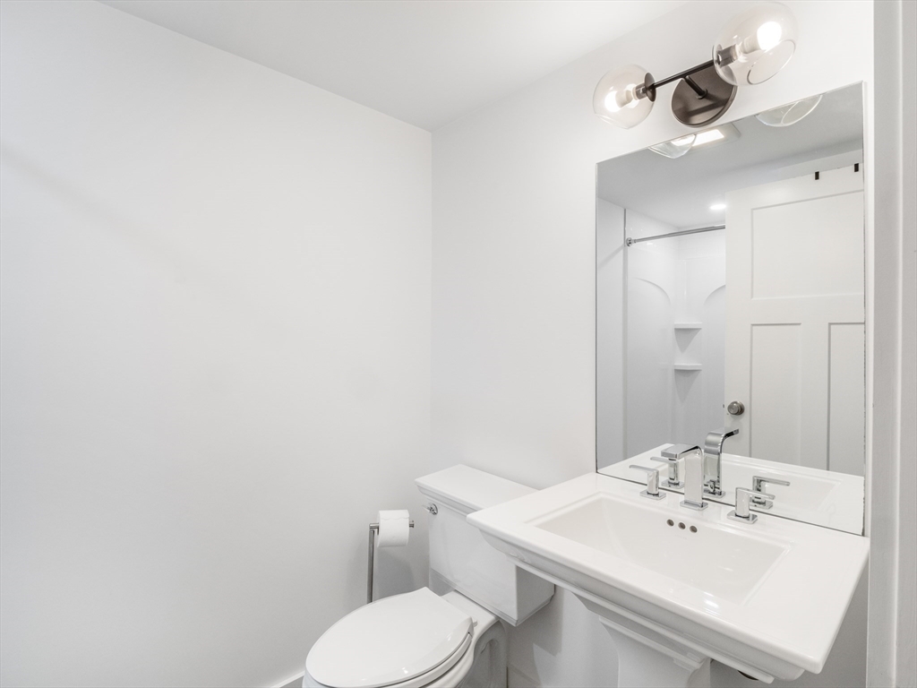 12 Hines, Unit 12 Newburyport, MA 01950 - Photo 9 of 32 a bathroom with a sink a toilet and mirror