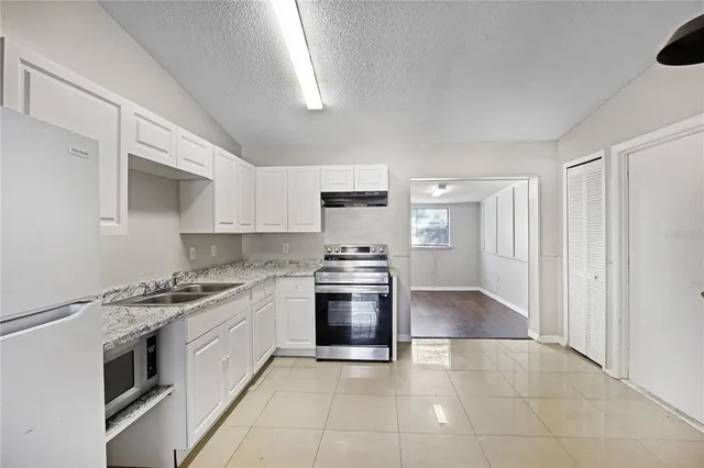 a kitchen with stainless steel appliances granite countertop a stove and a sink