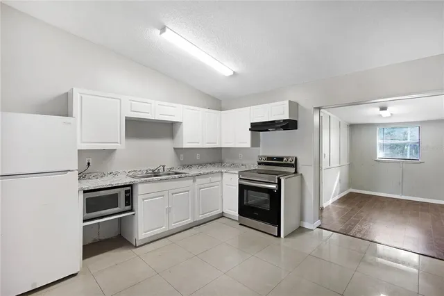 a kitchen with stainless steel appliances granite countertop a stove and a refrigerator