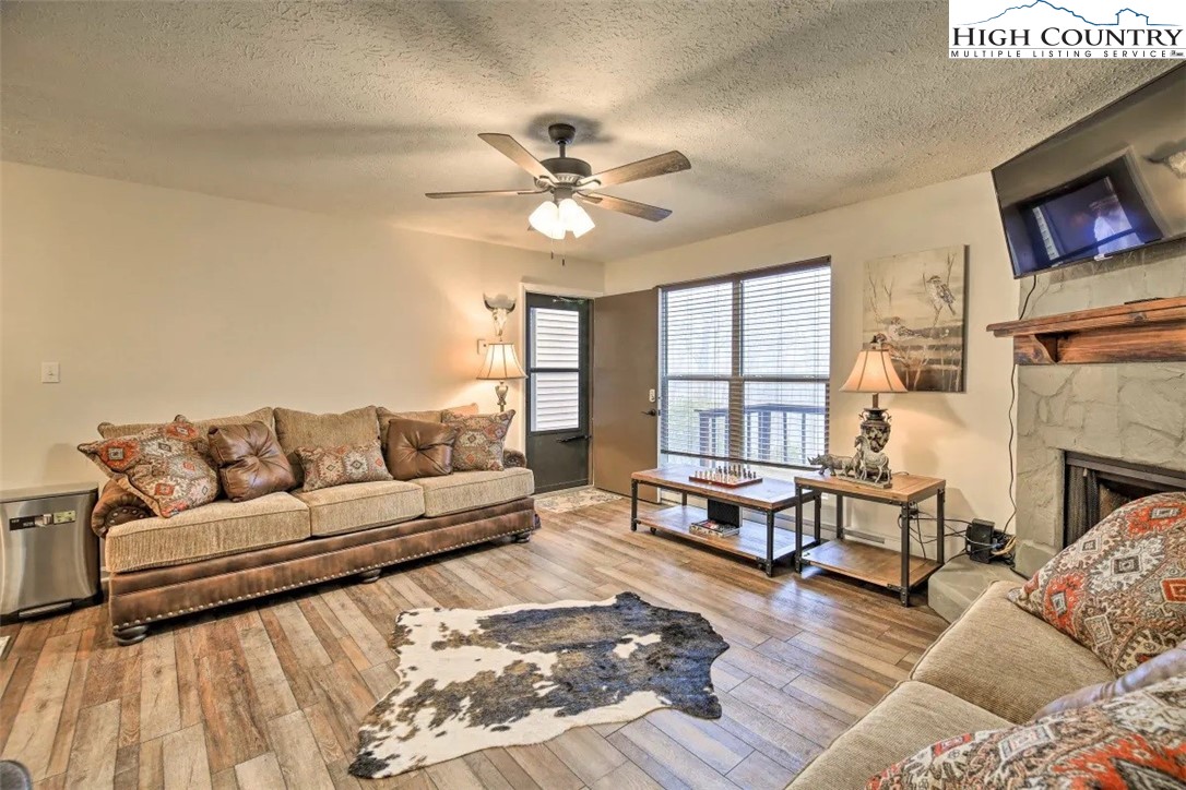1664 Grouse Moor Drive, Unit 1 Sugar Mountain, NC 28604 - Photo 11 of 27 a living room with furniture window and a fireplace