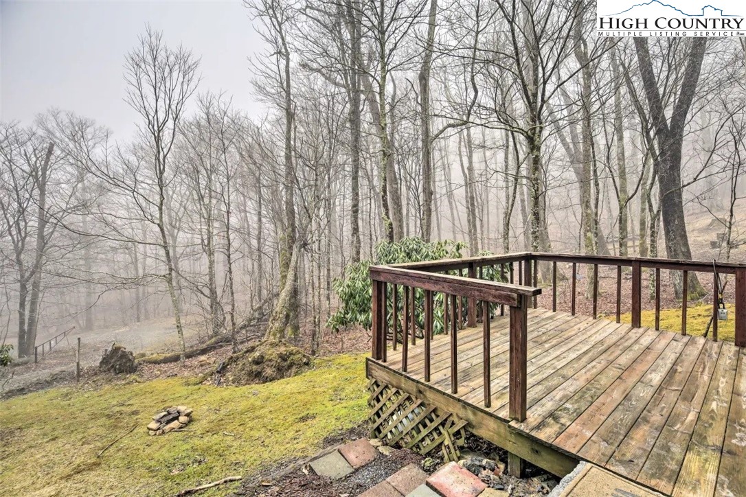 1664 Grouse Moor Drive, Unit 1 Sugar Mountain, NC 28604 - Photo 21 of 27 a view of deck with large trees and wooden fence