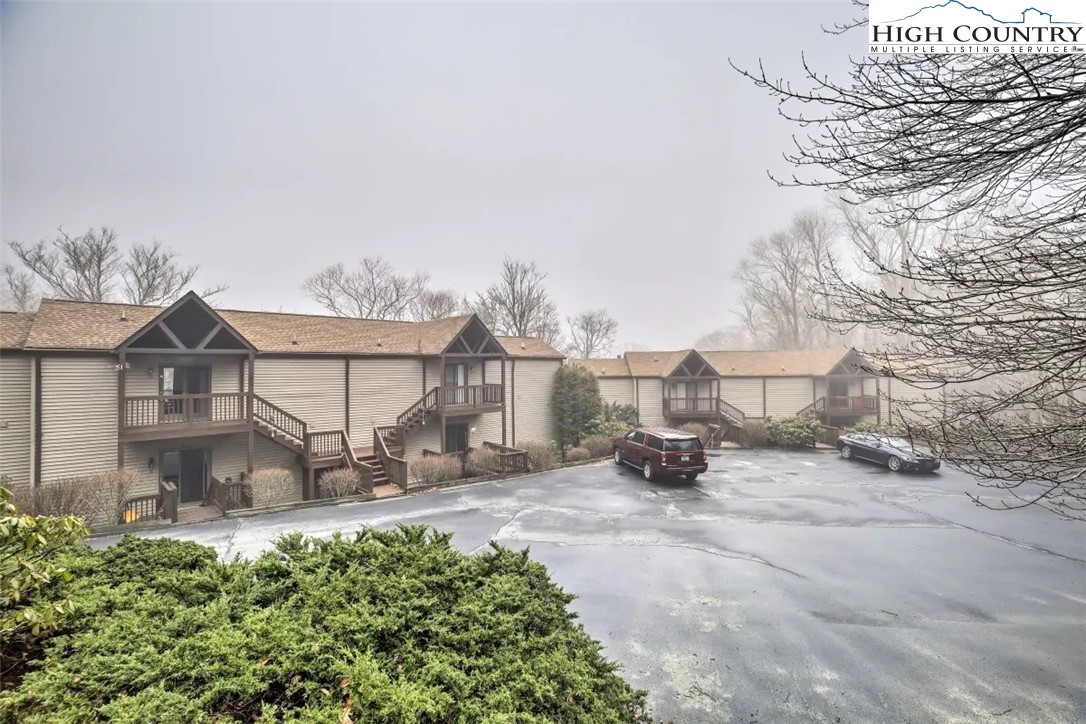 1664 Grouse Moor Drive, Unit 1 Sugar Mountain, NC 28604 - Photo 27 of 27 a view of a white house with a yard and sitting area