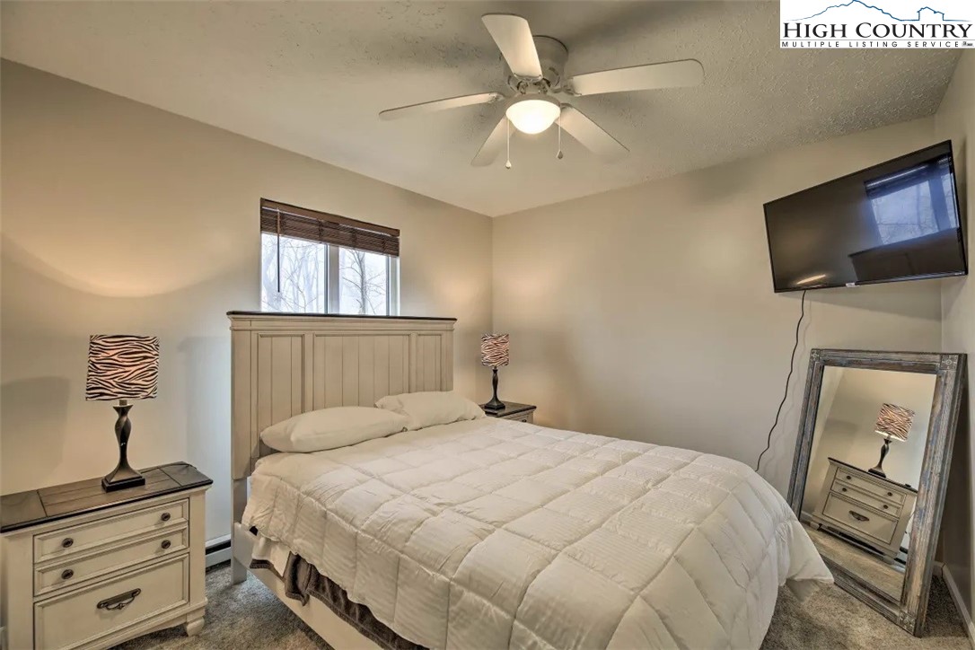 1664 Grouse Moor Drive, Unit 1 Sugar Mountain, NC 28604 - Photo 10 of 27 a bedroom with a bed and a flat screen tv