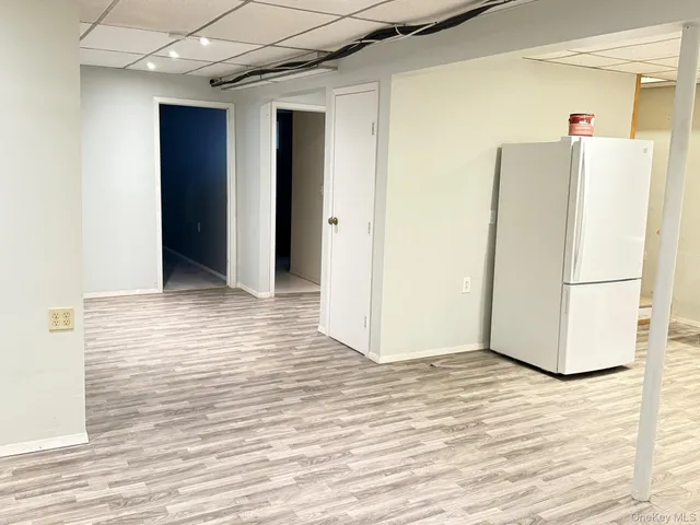 a view of a refrigerator in kitchen and wooden floor