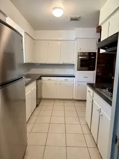 a kitchen with a sink a stove and refrigerator