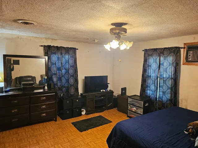 a bedroom with a bed and a dresser