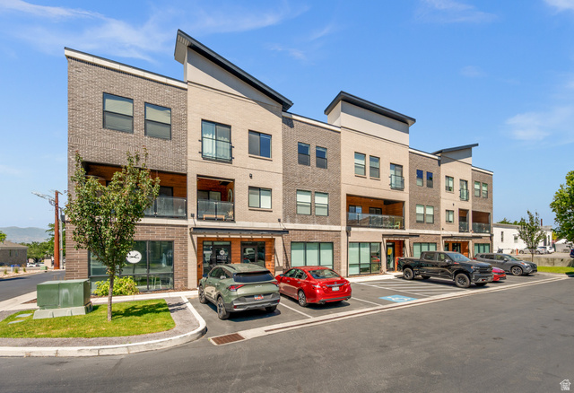 Modern multi-story building featuring brick and paneling exterior