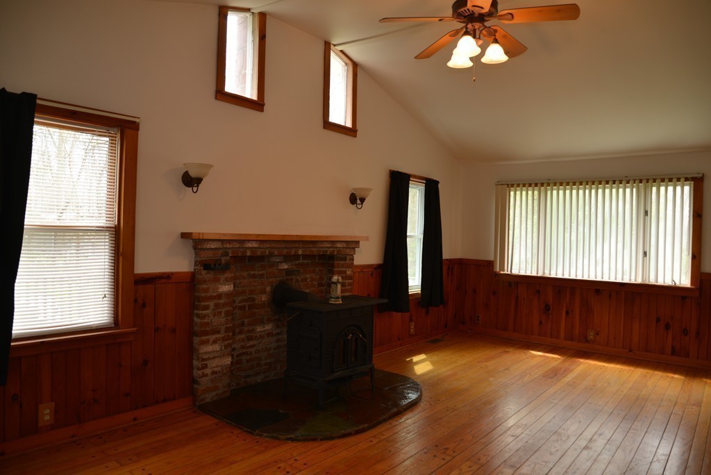785 Bulgarmarsh Road Tiverton, RI 02878 - Photo 5 of 28 a living room with fireplace furniture and a window
