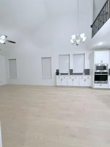 a view of a kitchen with a sink and chandelier