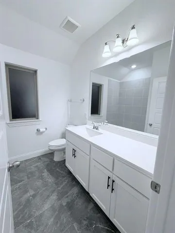 a bathroom with a double vanity sink and mirror