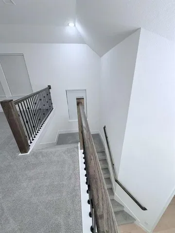 a view of a hallway with staircase