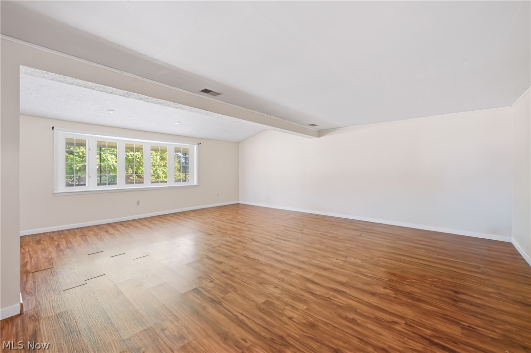 1501 Ohltown McDonald Road Mineral Ridge, OH 44440 - Photo 14 of 32 Spacious room featuring wood-finish flooring, a vaulted ceiling, and recessed lighting