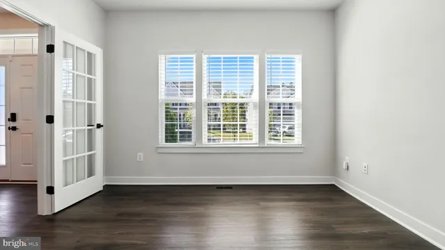a view of kitchen and hall with wooden floor