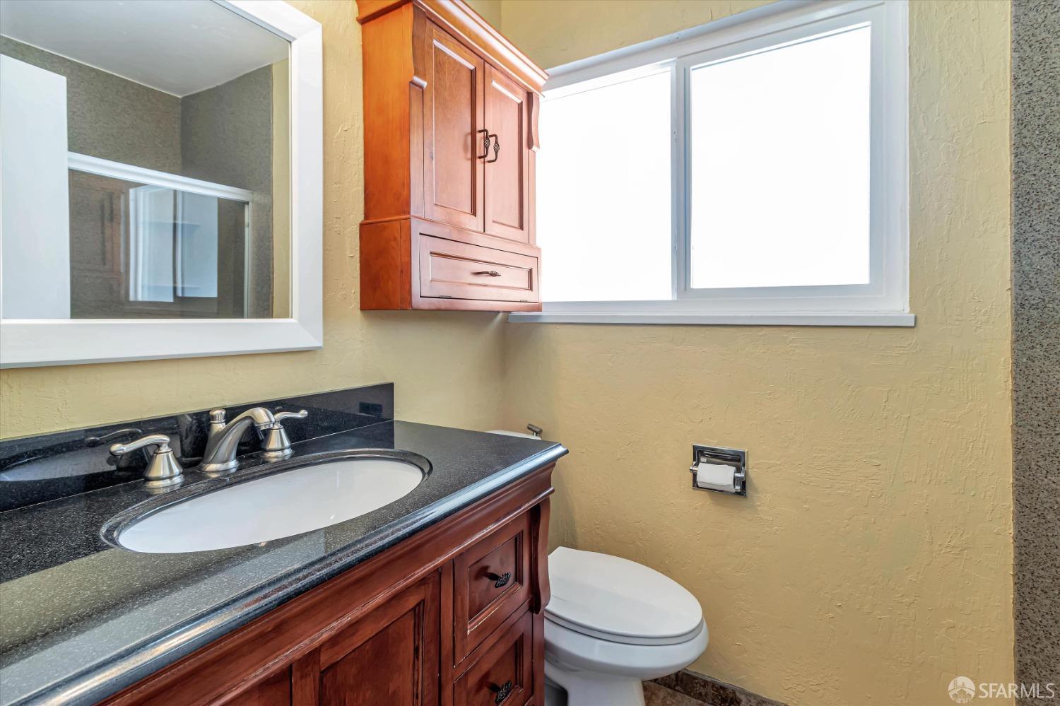 3 Harran Circle Orinda, CA 94563 - Photo 20 of 34 a bathroom with a granite countertop toilet sink and mirror