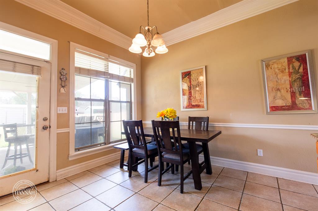 6531 North Liberty Way Keithville, LA 71047 - Photo 12 of 28 a view of a dining room with furniture and chandelier
