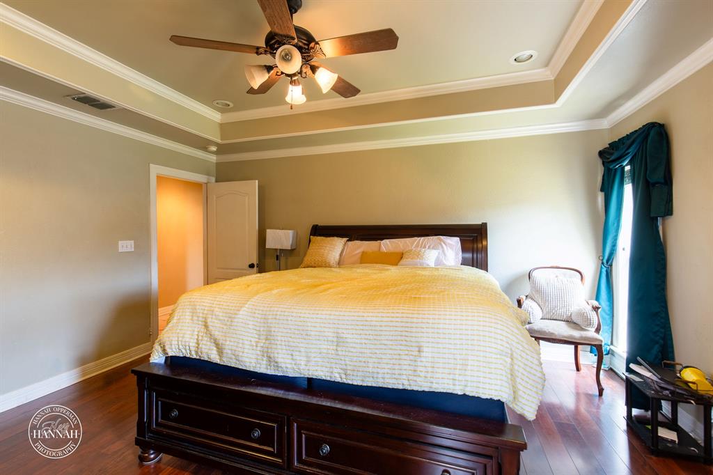 6531 North Liberty Way Keithville, LA 71047 - Photo 13 of 28 a bedroom with a bed and wooden floor